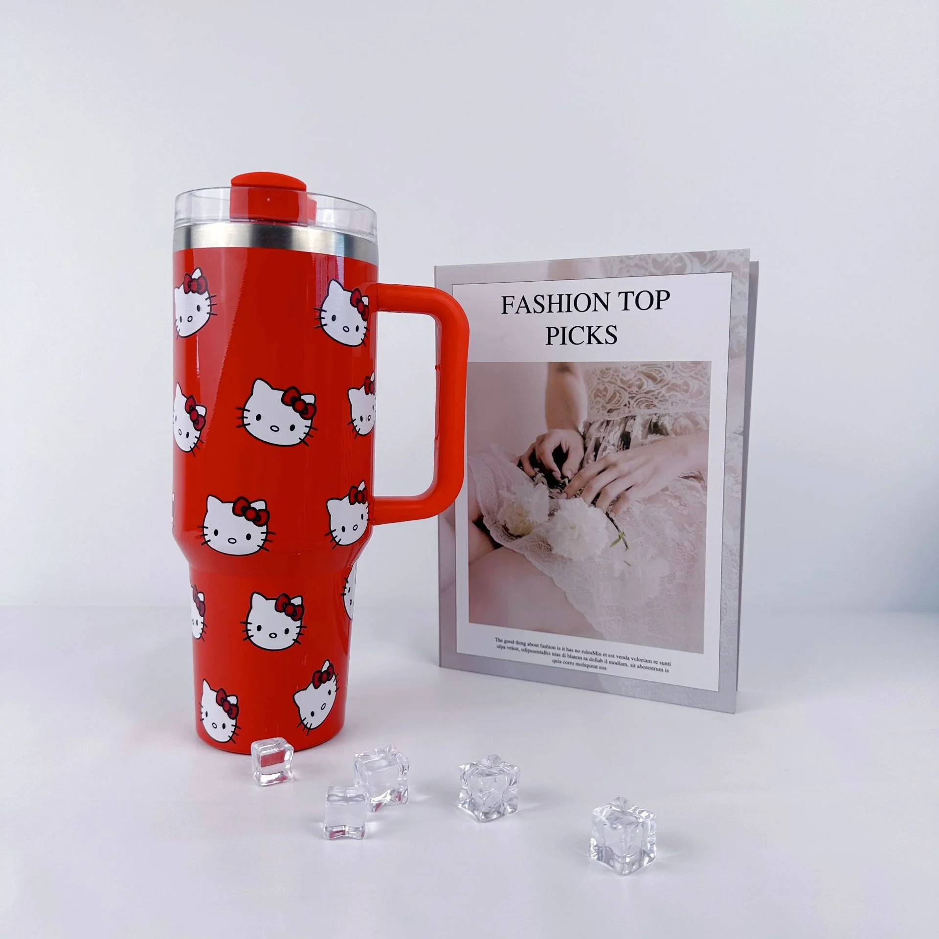 Cană roșie Hello Kitty Stanley cu capac și mâner transparent, expusă pe o masă albă