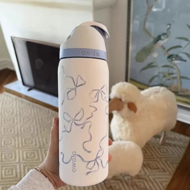 blue bow owala water bottle front view in hand