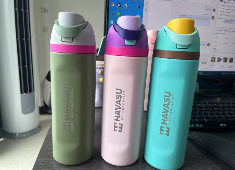 engraved Owala bottles in silver, green, and purple with logo